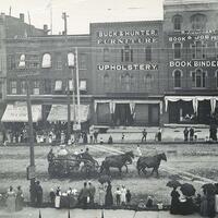 Horse drawn fire tankers in parade with onlookers