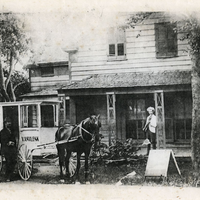 black and white image of a horse and carriage outside of bakery