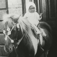 Child sits on a pony