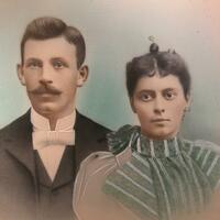 Color portrait photograph of couple in dressy clothing